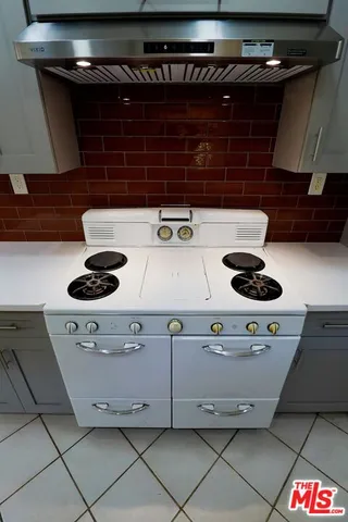 a close up of a stove top oven sitting inside of a kitchen