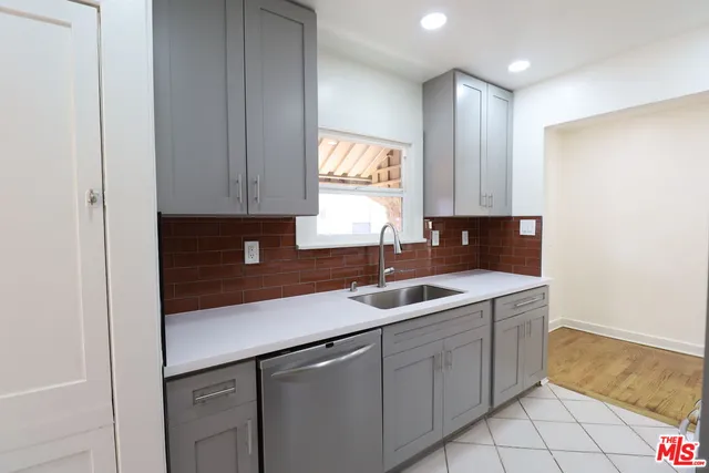 a kitchen with a sink and cabinets