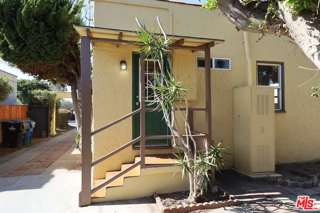 a view of a house with backyard and wooden floor