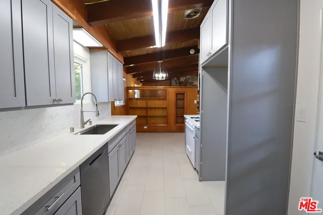 a kitchen with sink and cabinets