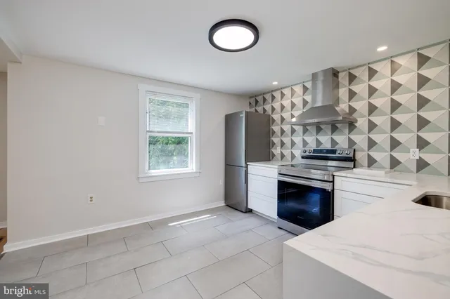 a view of kitchen with white cabinets