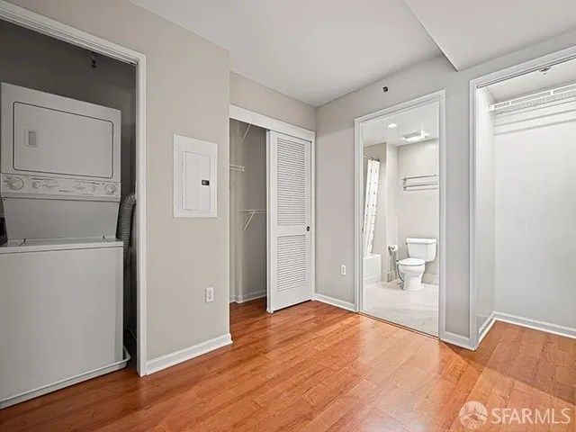 a view of empty room with wooden floor