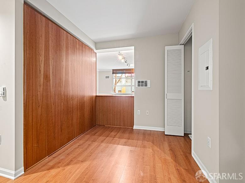 1701 Jackson Street, Unit 105 San Francisco, CA 94109 - Photo 15 of 43 an empty room with wooden floor windows and entrance