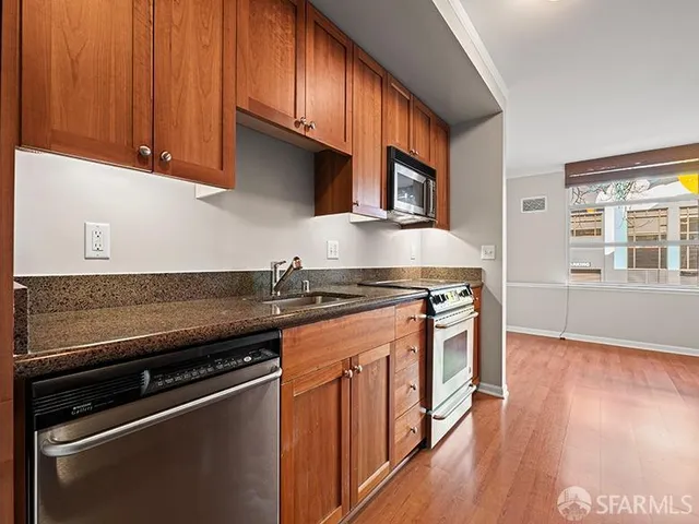 a kitchen with stainless steel appliances granite countertop a stove and a sink