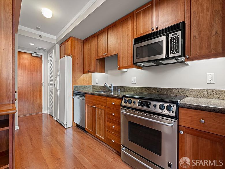 1701 Jackson Street, Unit 105 San Francisco, CA 94109 - Photo 19 of 43 a kitchen with stainless steel appliances granite countertop a stove microwave and refrigerator