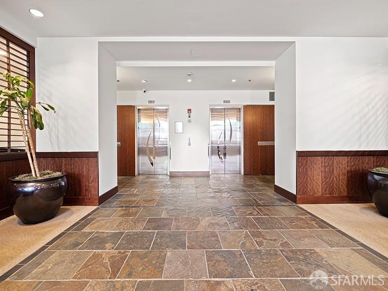 1701 Jackson Street, Unit 105 San Francisco, CA 94109 - Photo 6 of 43 a view of a hallway with wooden floor and furniture