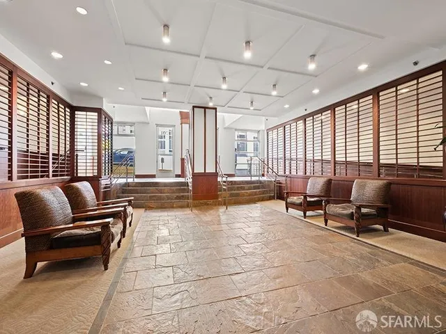 a lobby with furniture and floor to ceiling window