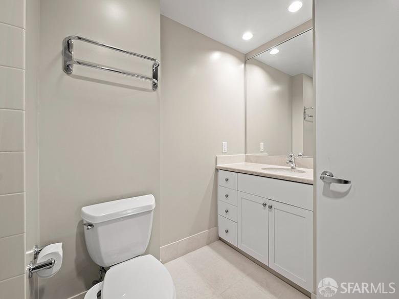 1701 Jackson Street, Unit 105 San Francisco, CA 94109 - Photo 9 of 43 a bathroom with a toilet a sink and mirror