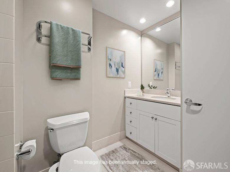 1701 Jackson Street, Unit 105 San Francisco, CA 94109 - Photo 10 of 43 a bathroom with a toilet sink and mirror