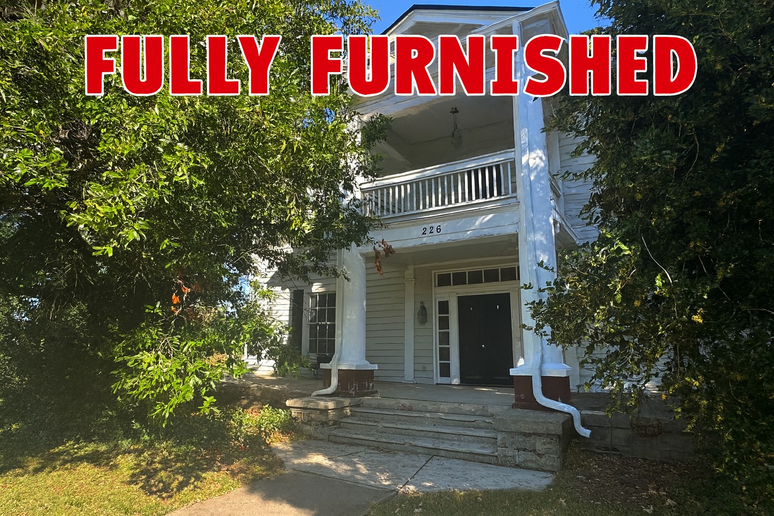 226 North Highland Avenue, Unit 4 Murfreesboro, TN 37130 - Photo 1 of 9 a front view of a house with a yard and potted plants