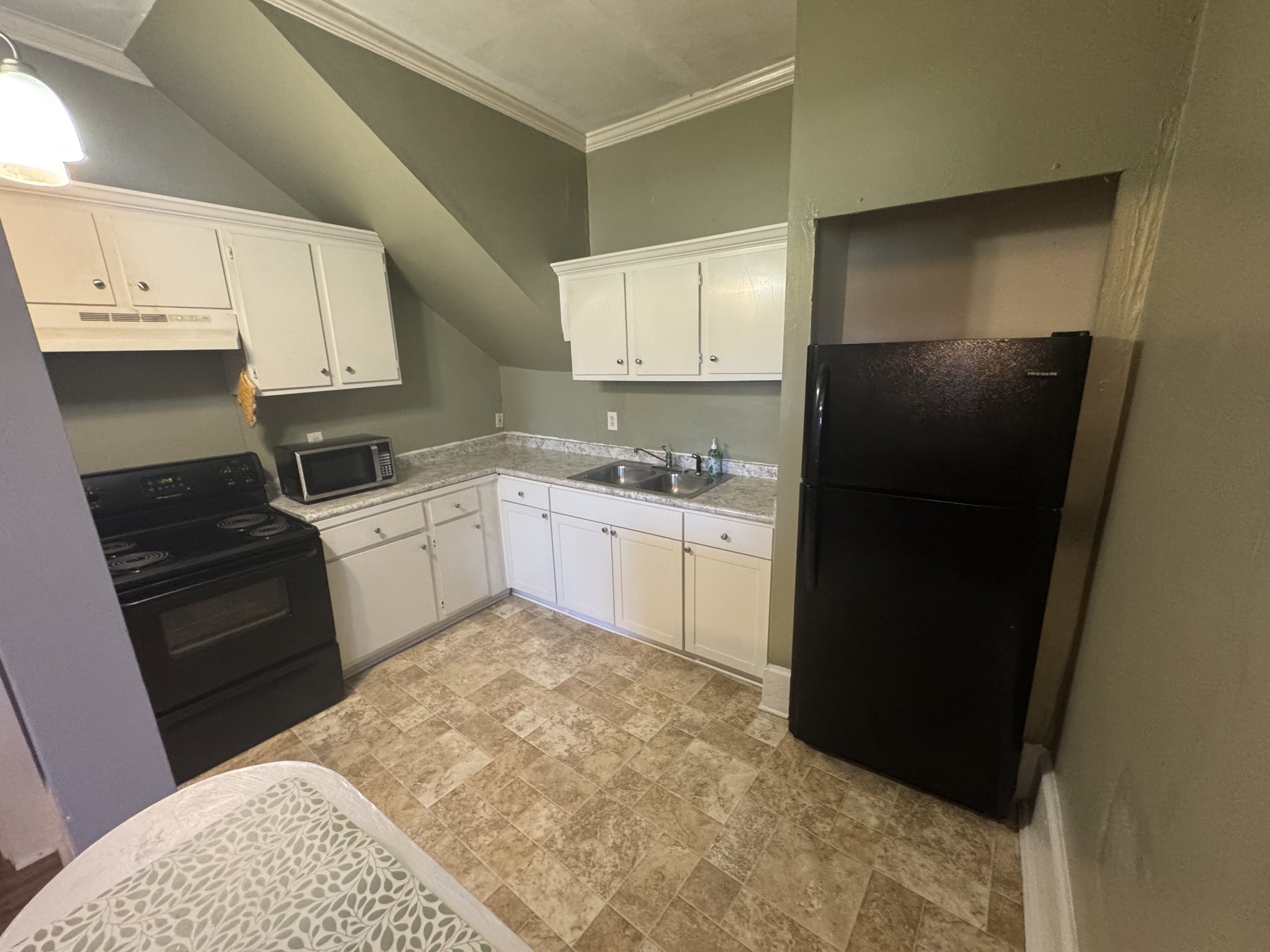 226 North Highland Avenue, Unit 4 Murfreesboro, TN 37130 - Photo 4 of 9 a kitchen with a sink a stove and refrigerator