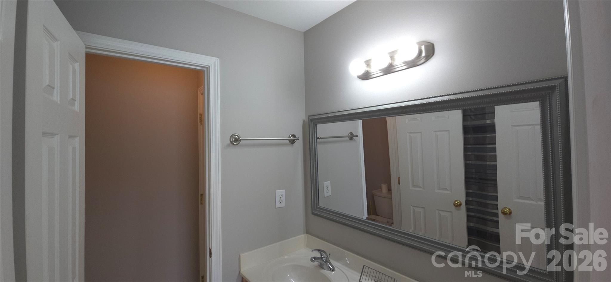 11542 Rabbit Ridge Road Charlotte, NC 28270 - Photo 19 of 33 a view of a hallway with wooden floor and a bathroom