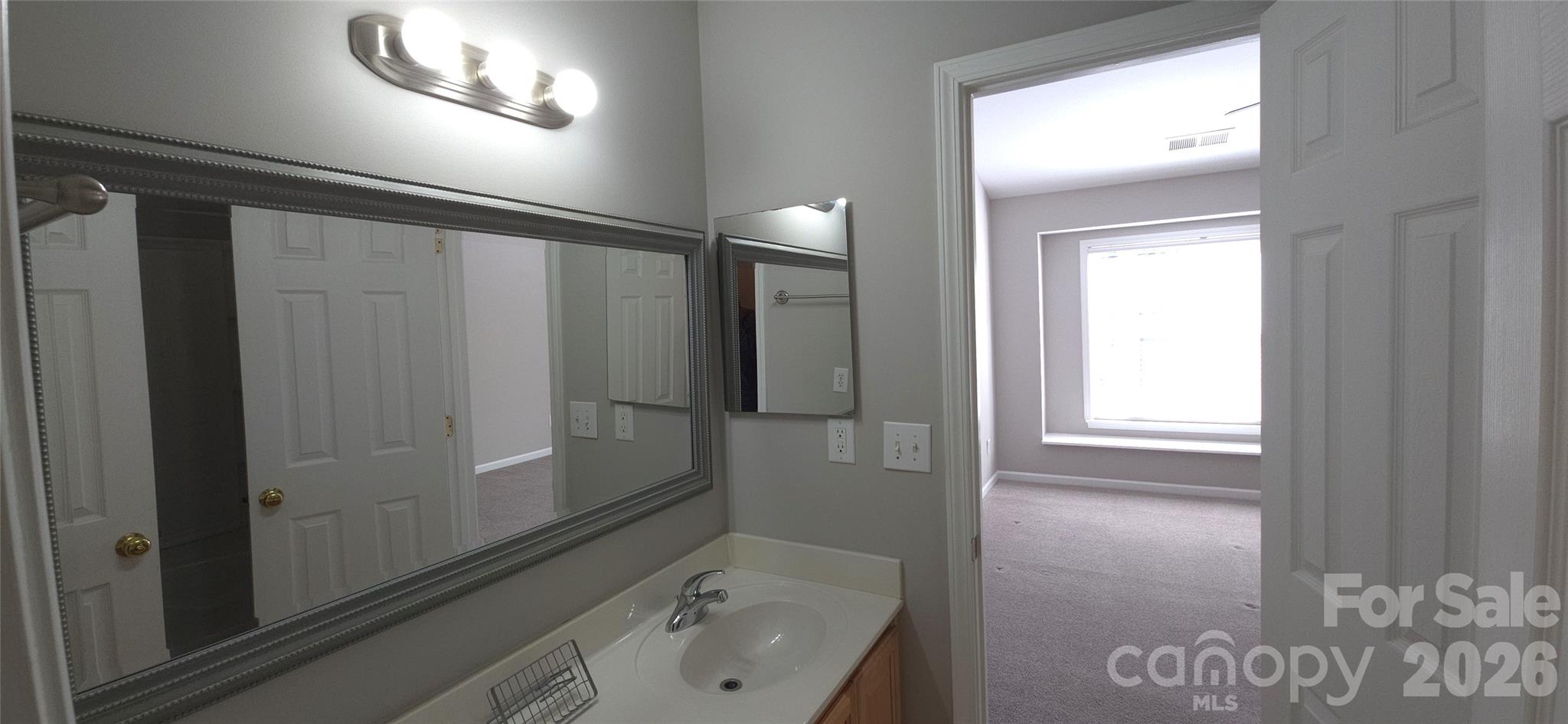 11542 Rabbit Ridge Road Charlotte, NC 28270 - Photo 20 of 33 a bathroom with a sink and mirror