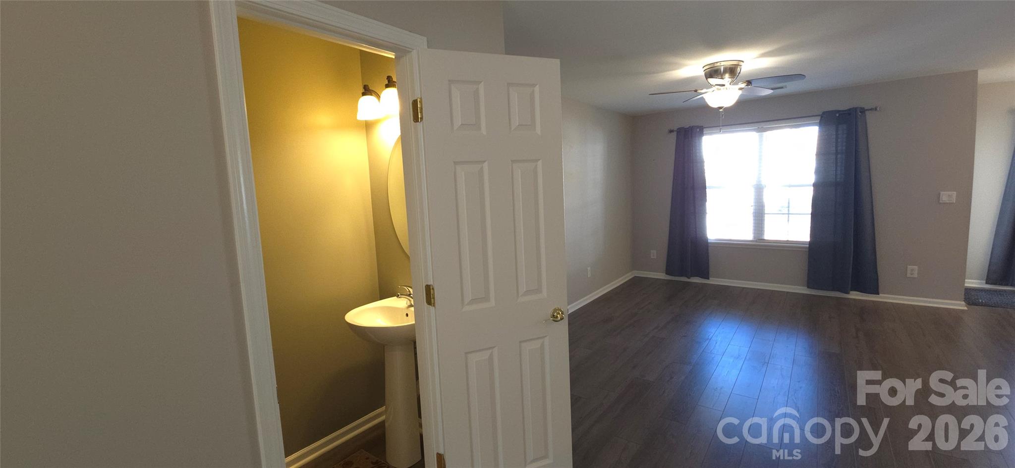 11542 Rabbit Ridge Road Charlotte, NC 28270 - Photo 4 of 33 a view of an empty room with window and wooden floor