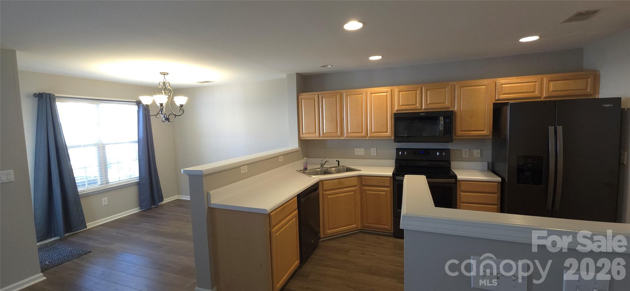 11542 Rabbit Ridge Road Charlotte, NC 28270 - Photo 5 of 33 a kitchen with a refrigerator and a stove
