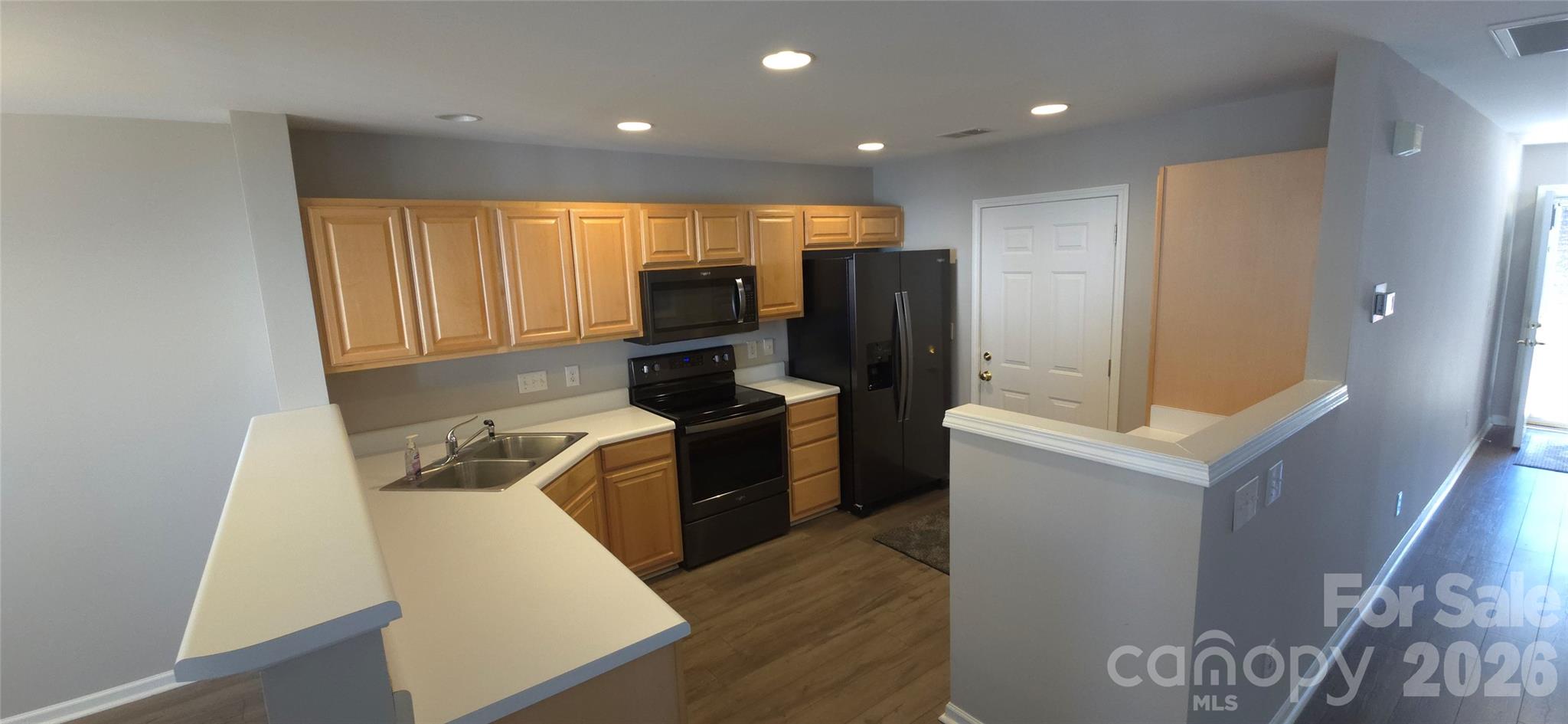 11542 Rabbit Ridge Road Charlotte, NC 28270 - Photo 8 of 33 a kitchen with a refrigerator and a stove