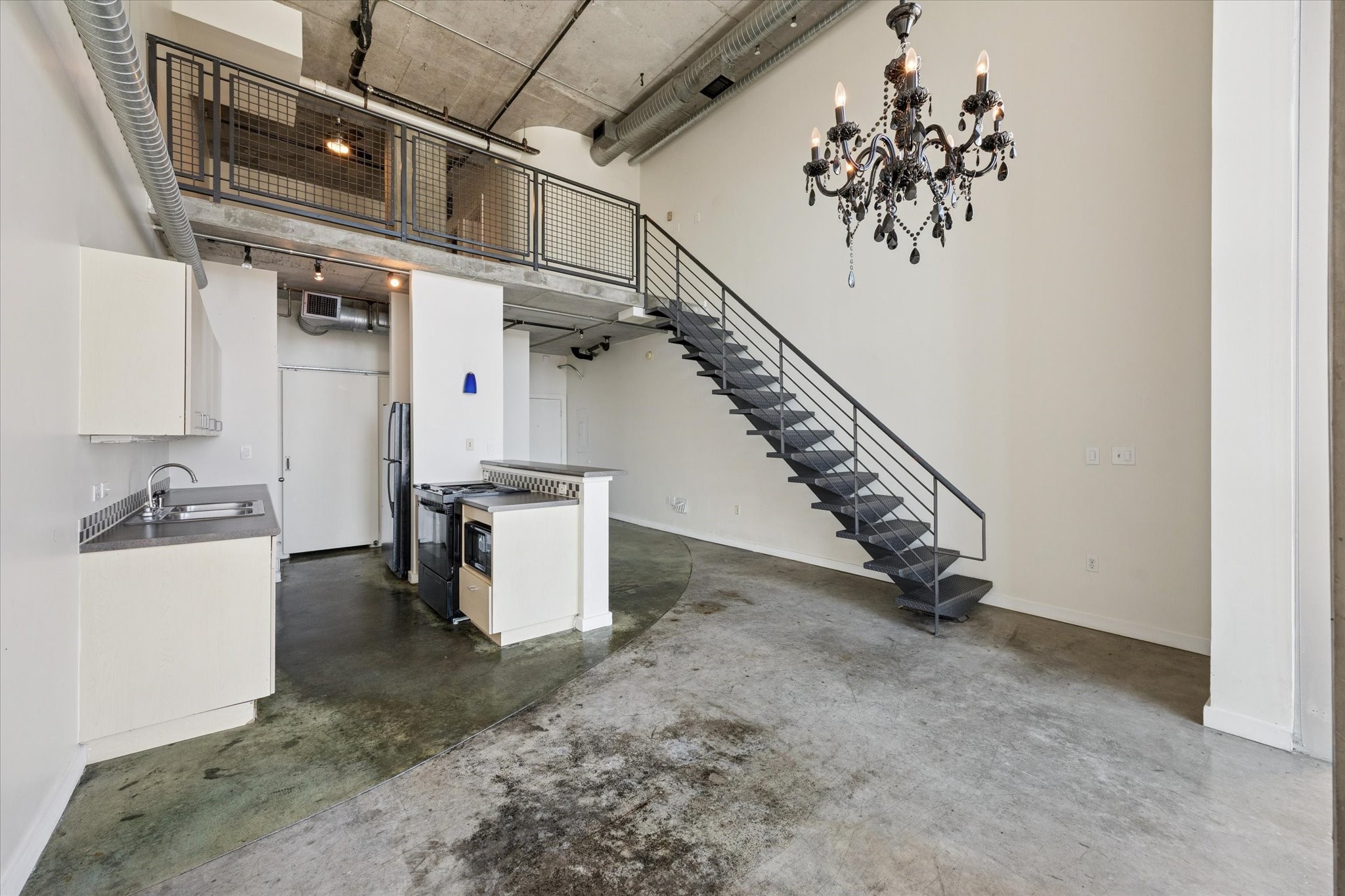 2000 Bagby Street, Unit 13432 Houston, TX 77002 - Photo 5 of 27 a view of a hallway with stairs and a chandelier