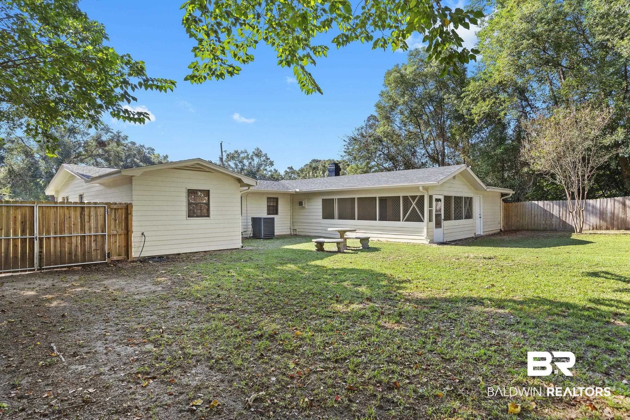 4366 Barden Avenue Mobile, AL 36619 - Photo 11 of 40 Rear view of house featuring cooling unit, a sunroom, and a lawn