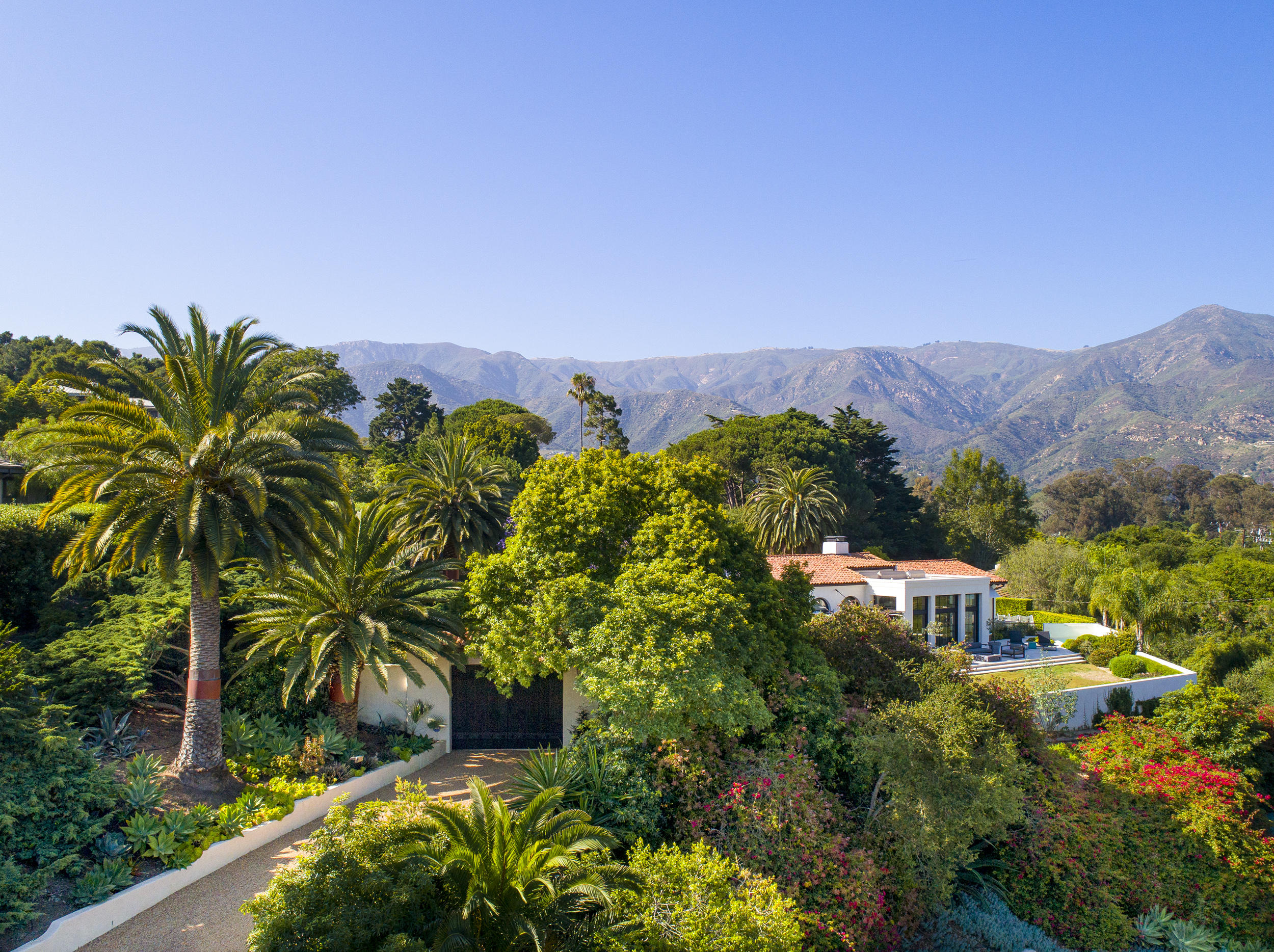 698 El Rancho Road Montecito, CA 93108 - Photo 24 of 24 a view of a garden with a building in the background