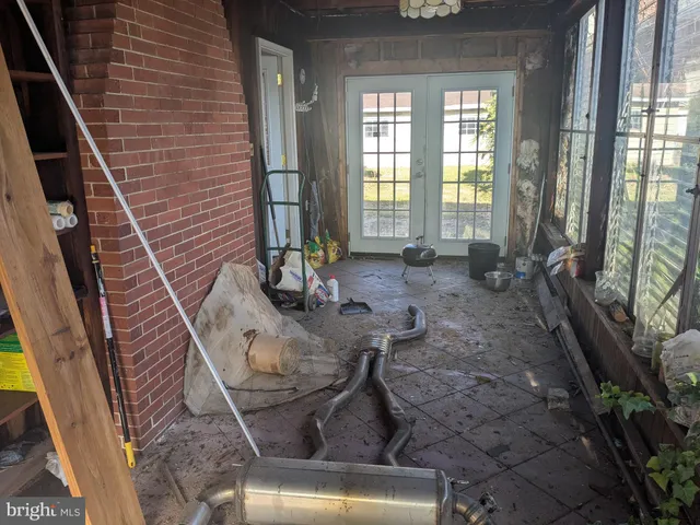 a view of a livingroom with furniture and floor to ceiling window