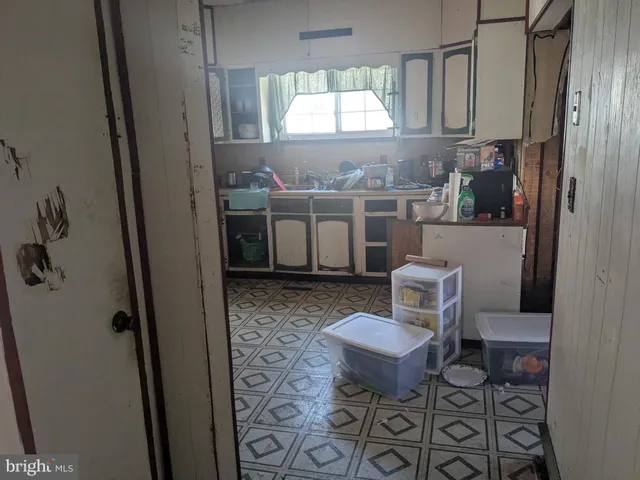 a living room with furniture a window and a table