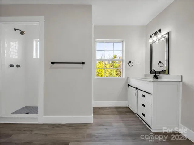a bathroom with a granite countertop sink a mirror and a window