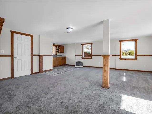 a view of a livingroom with furniture and staircase