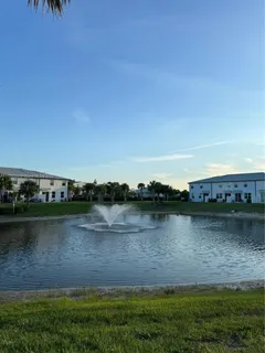 a view of a lake with houses in the back