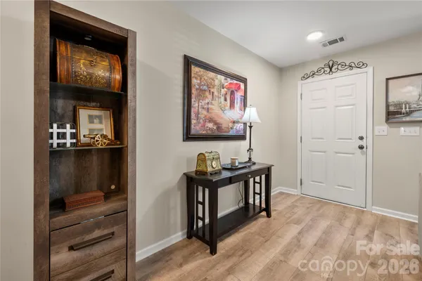 a view of a livingroom with wooden floor and cabinet