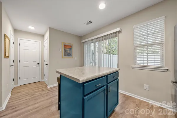 a kitchen that has a sink a window and a refrigerator