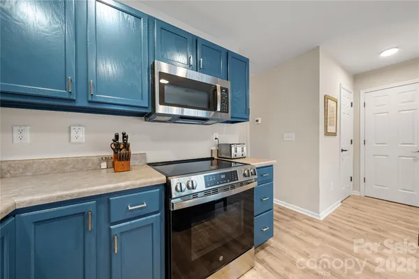 a kitchen with stainless steel appliances granite countertop a sink stove and microwave