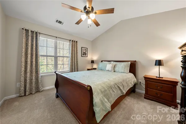 a spacious bedroom with a bed and a window