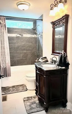 a living room with furniture a flat screen tv and a floor to ceiling window