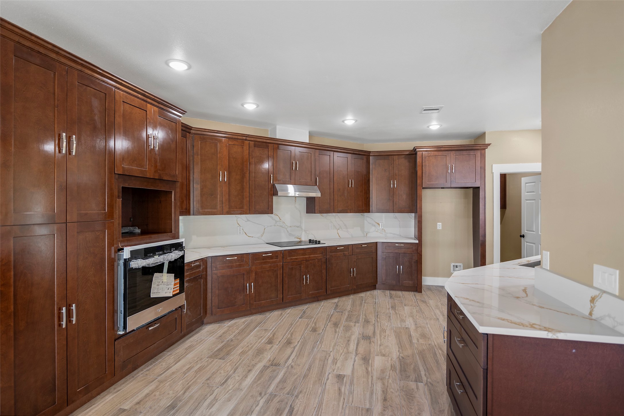 24630 Cavan Street Hempstead, TX 77445 - Photo 14 of 31 a large kitchen with a sink and stainless steel appliances