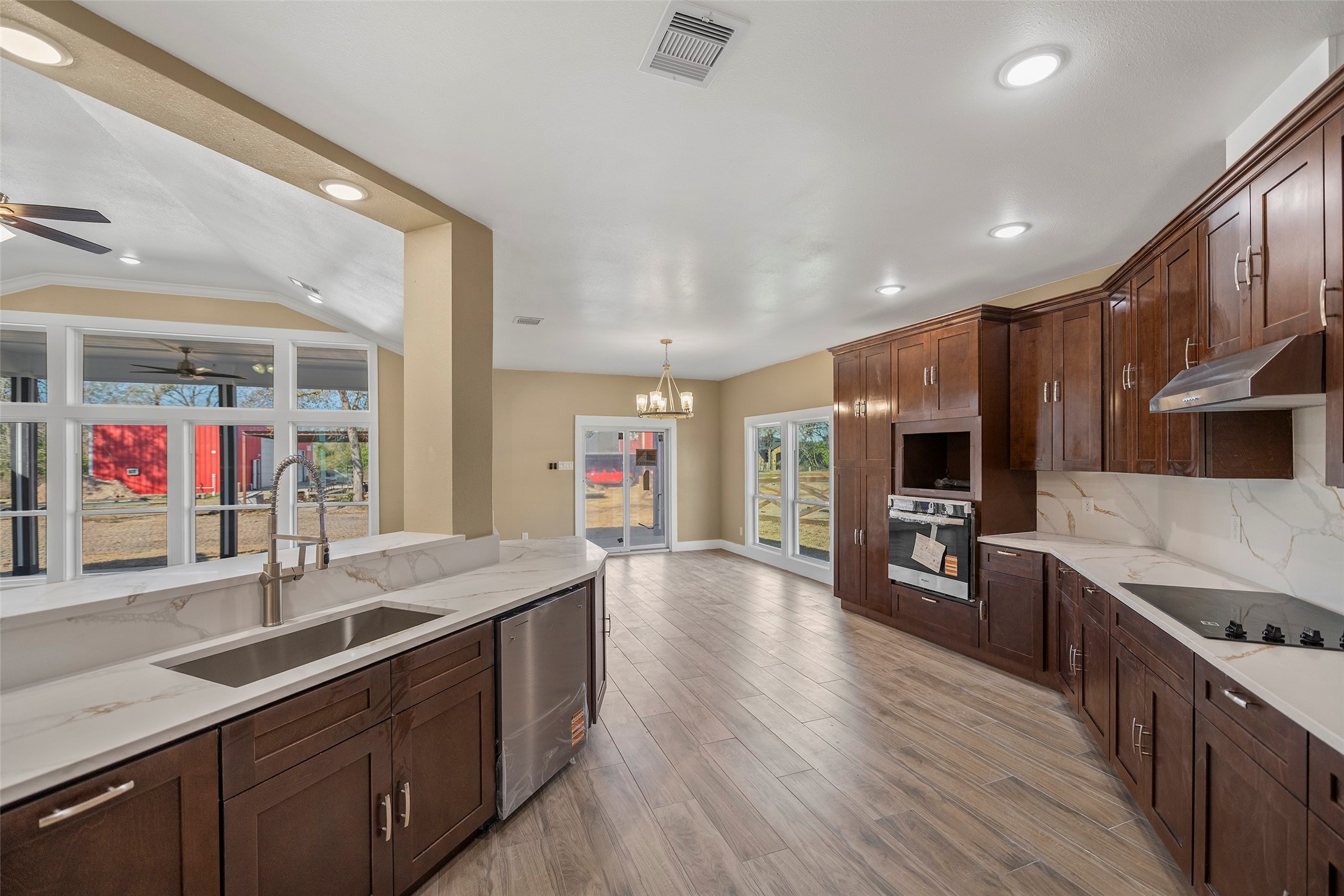 24630 Cavan Street Hempstead, TX 77445 - Photo 16 of 31 a large kitchen with stainless steel appliances granite countertop a large island in the center