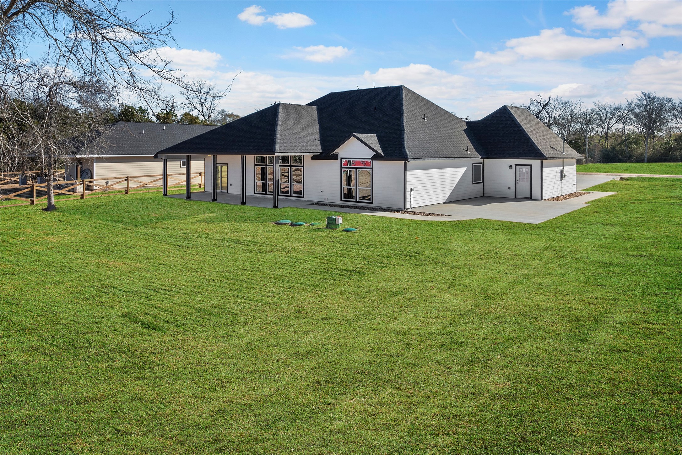 24630 Cavan Street Hempstead, TX 77445 - Photo 19 of 31 a view of a house with a big yard potted plants and large trees