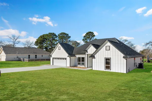 a view of house with yard and entertaining space