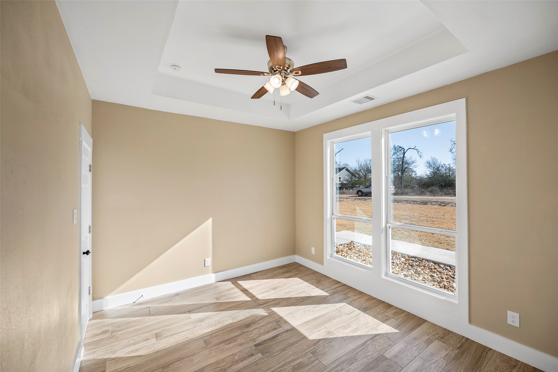 24630 Cavan Street Hempstead, TX 77445 - Photo 4 of 31 a view of an empty room with wooden floor and a window