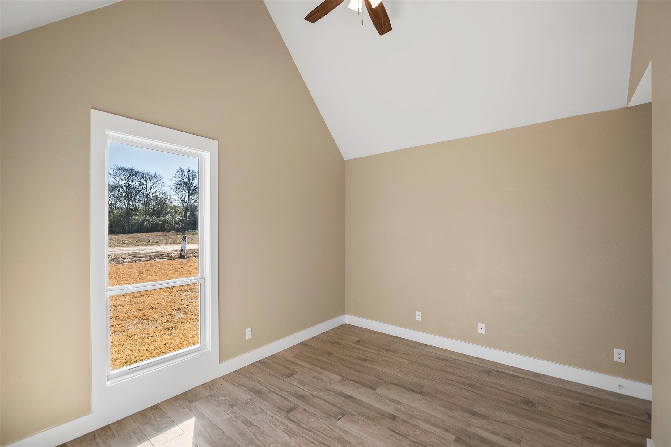 24630 Cavan Street Hempstead, TX 77445 - Photo 7 of 31 a view of an empty room with wooden floor and a window