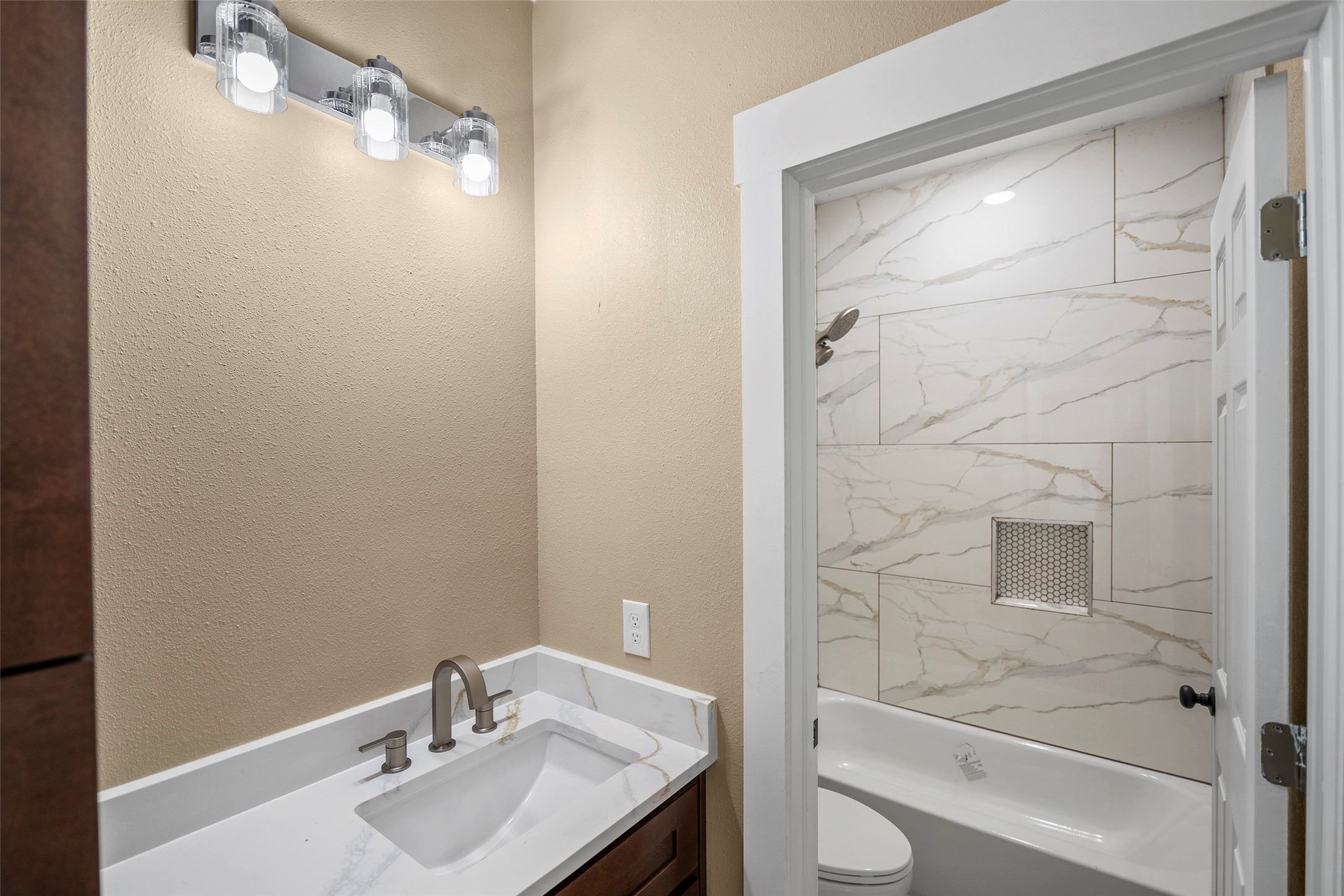 24630 Cavan Street Hempstead, TX 77445 - Photo 9 of 31 a bathroom with a granite countertop sink toilet and shower