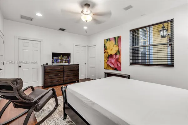 a living room with furniture and a view of kitchen