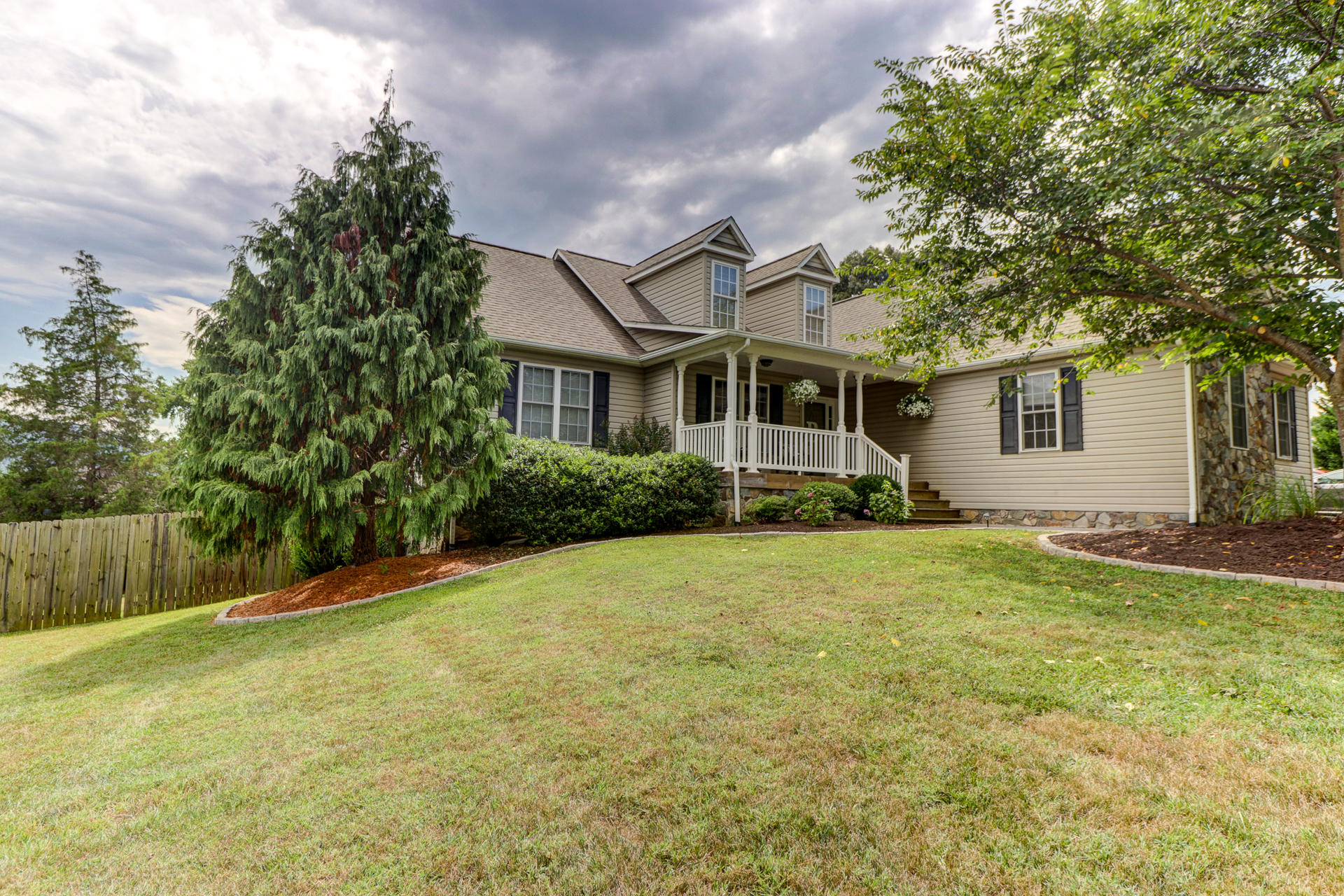 a front view of house with yard and trees
