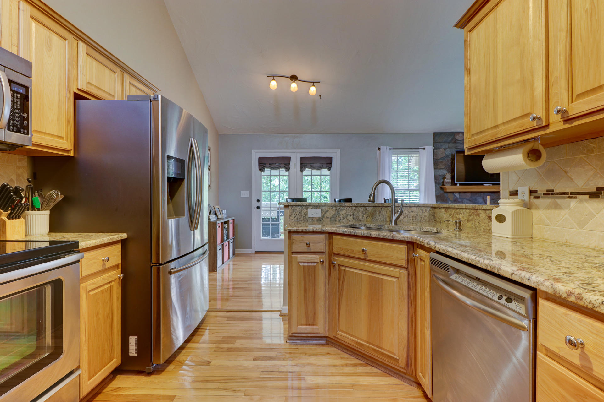 1275 Virginia Ridge Drive Hardy, VA 24101 - Photo 17 of 44 a kitchen with stainless steel appliances granite countertop a refrigerator a sink dishwasher and wooden cabinets with wooden floor