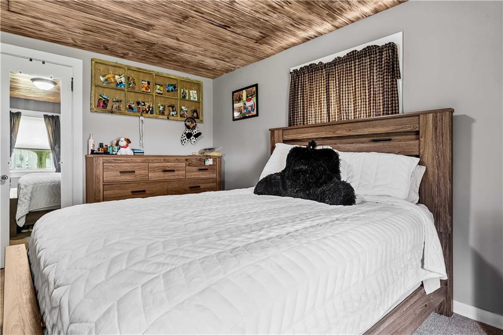 210 Hopwood Fairchance Road Uniontown, PA 15401 - Photo 10 of 28 a bedroom with a bed and a large mirror