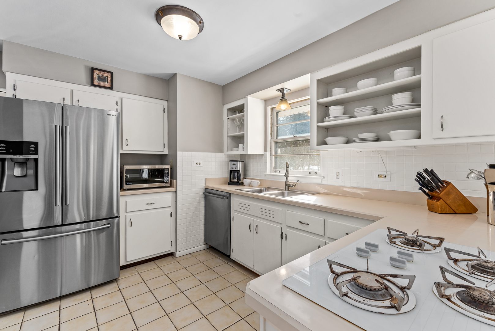 27W420 Manchester Road Winfield, IL 60190 - Photo 8 of 24 a kitchen with stainless steel appliances granite countertop a sink dishwasher a refrigerator and a stove with wooden floor