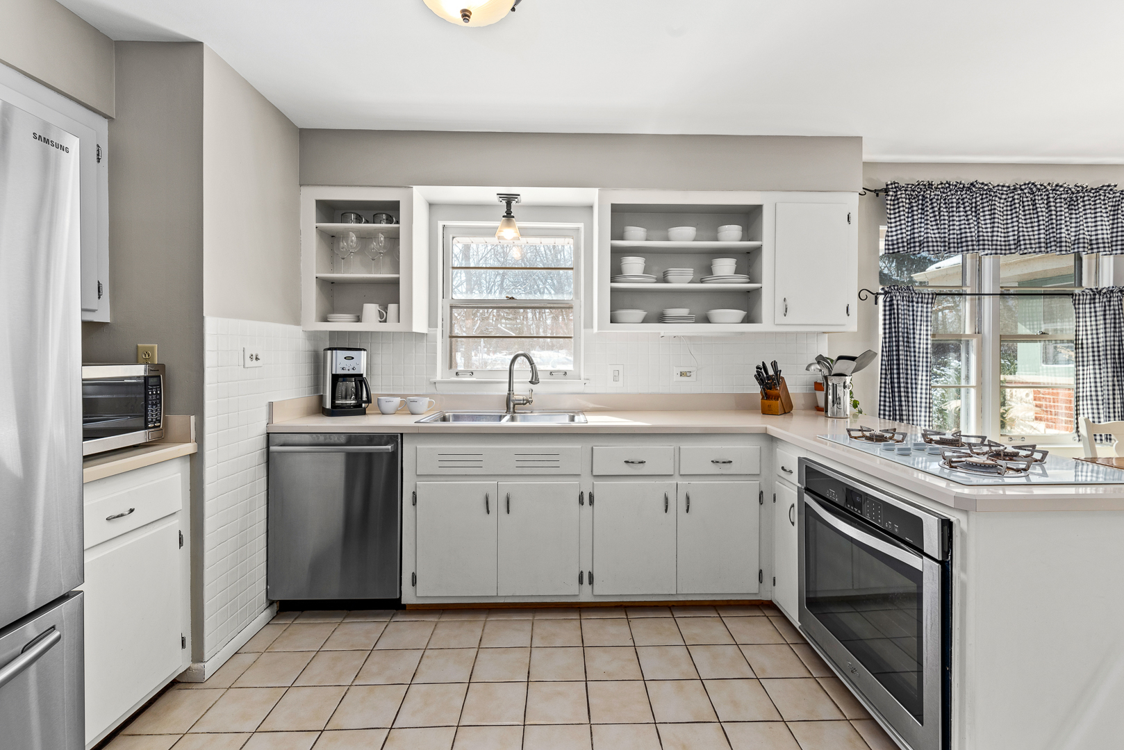 27W420 Manchester Road Winfield, IL 60190 - Photo 9 of 24 a kitchen with a sink stove and cabinets