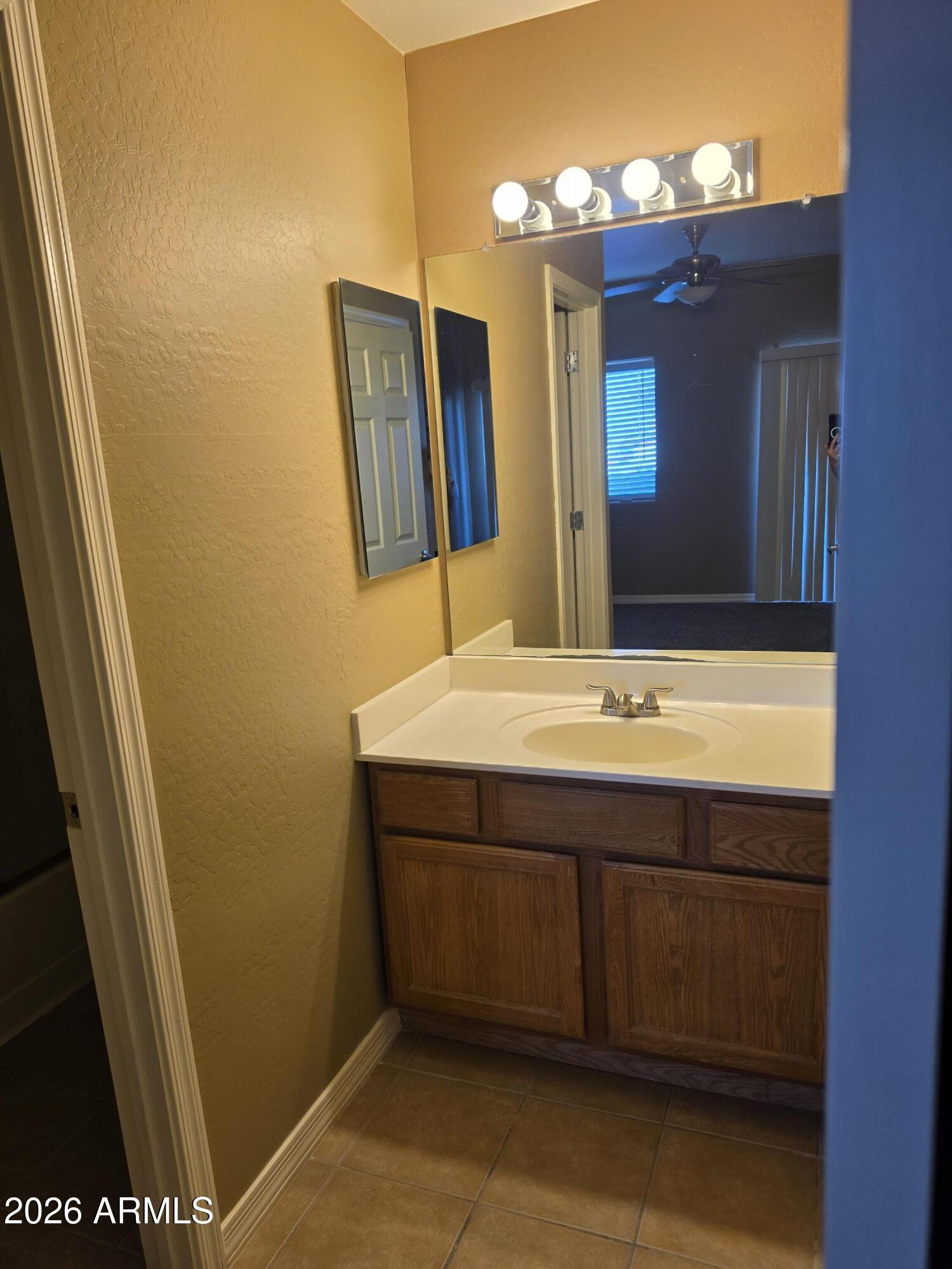 537 South Delaware Drive, Unit 104 Apache Junction, AZ 85120 - Photo 11 of 19 a bathroom with a sink and a mirror