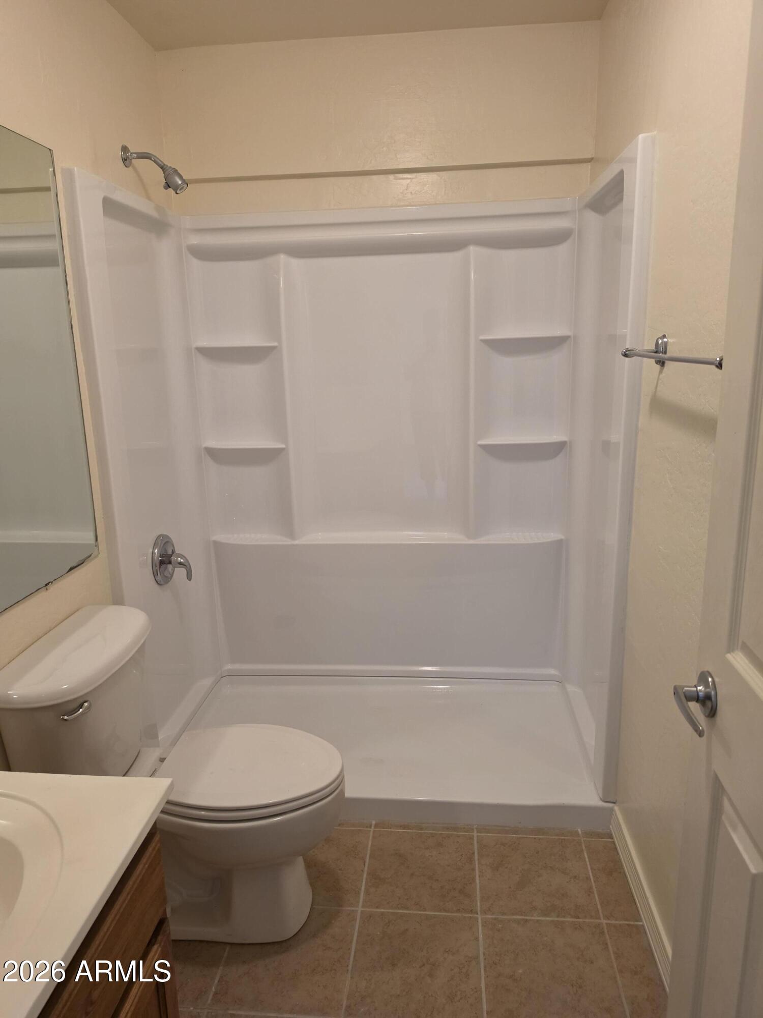 537 South Delaware Drive, Unit 104 Apache Junction, AZ 85120 - Photo 13 of 19 a bathroom with a toilet and a shower