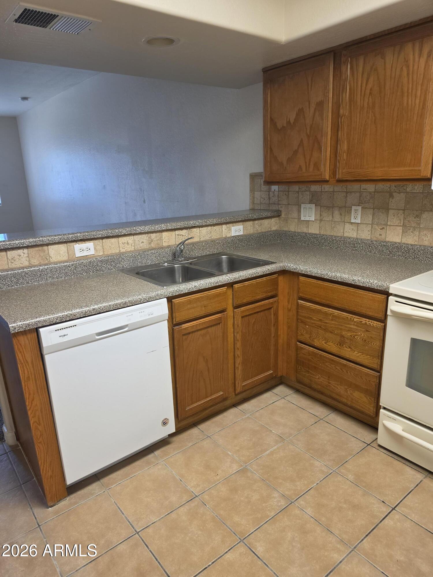 537 South Delaware Drive, Unit 104 Apache Junction, AZ 85120 - Photo 5 of 19 a kitchen with a sink and cabinets