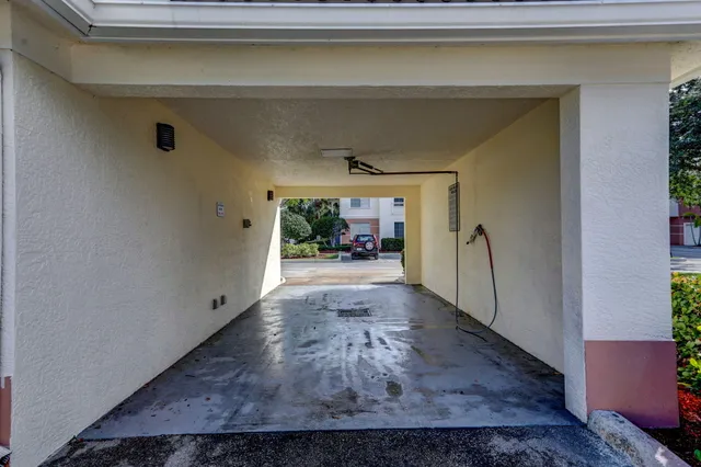 a view of a house with a chairs and table in a patio